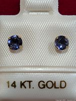 Front view of iolite stud earrings on display card showing 14 KT. GOLD text
