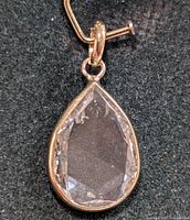 Front view of teardrop lab diamond pendant in yellow gold bezel