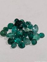 group of loose faceted emeralds