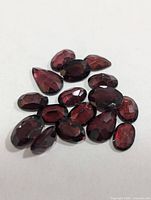 Group of loose faceted garnets on white background