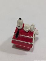 Side view of silver Snoopy doghouse charm bead
