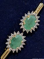 front view showing emerald and halo stones