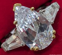 Front view showing pear-shaped CZ and side stones