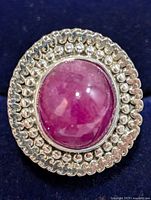 Top view showing ruby cabochon and beaded halo