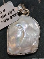 Front view of baroque pearl pendant in silver bezel with bail