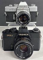 Front view of both cameras showing model names and lenses
