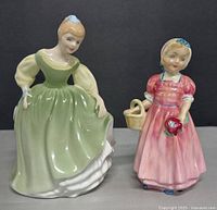 Front view of both Royal Doulton figurines showing colors and poses