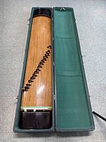 Zither in open case showing full length