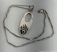 Chain coiled with pendant displayed