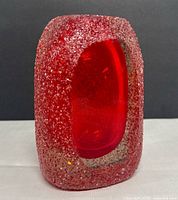 Front view showing oval red interior and frosted exterior texture