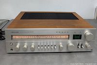 Front and top view of Realistic STA-240 receiver showing overall condition and wood-veneer cabinet