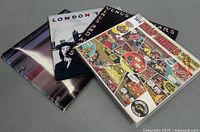 Stack of the four vinyl LPs showing cover art for Cheap Thrills, Wings Venus and Mars, Wings London Town and a partial unidentified album