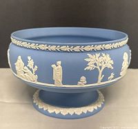 Side view showing relief figures and laurel rim