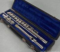 Flute disassembled in blue-lined case showing keywork and overall condition