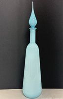 Full view of light blue genie decanter standing upright