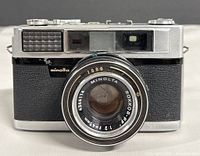 Front view showing Minolta AL camera and Rokkor-PF lens