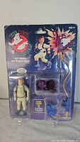 Front view of sealed Ray Stantz figure, accessories, and card graphic