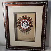 Frontal view of framed print within wood frame