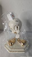 Tweety Bird figurine wrapped in original plastic showing gold accents and base