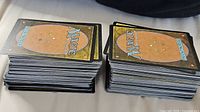 two stacks of Magic: The Gathering cards backs visible