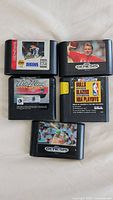Front view of all five Sega Genesis cartridges showing titles and label art