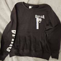 Front view of black sweatshirt with Ouija graphics