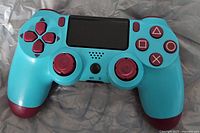 Front view of Berry Blue DualShock 4 showing buttons, touchpad and sticks