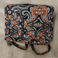 Front of quilted cotton backpack showing navy, orange, light blue and white paisley pattern