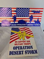 Two sign designs displayed upright showing graphics and text