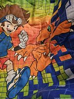 Close-up of Tai and Agumon graphics on comforter
