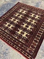 Full view of rectangular Turkmen rug showing overall design and fringe