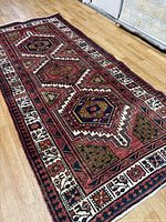 Full view of handmade Zanjan runner rug on wood floor