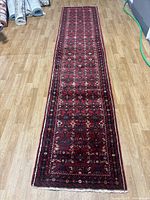 Full view of runner rug showing overall length, borders and field pattern