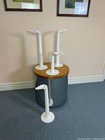 Four hand display stands of varying heights