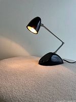 Lamp lit, showing shade, arm and base