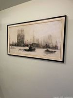 Framed city skyline painting on wall, showing overall artwork and frame