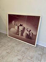 Full view of the framed print leaning against wall