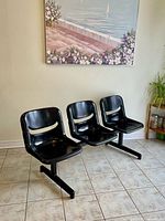 Front angled view of three-seat black tandem bench