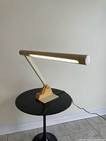 Entire lamp illuminated and adjusted on small round table