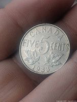 Reverse of 1933 Canada 5 cents showing denomination, year and maple leaves