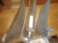 Three metal crescent moon candle wall sconces displayed on table, one shown with sample taper candle