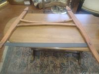 Overall view of wooden frame buck saw on table