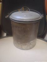 Front view showing entire tin lunch pail with lid and handle