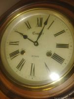Close-up of Chalet dial showing Roman numerals, brass bezel
