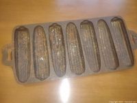 Top view of cast iron pan showing seven corn-shaped cavities