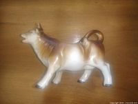 Left side view of ceramic cow creamer showing full profile