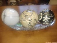 Three decorative glass spheres and cut glass dish overview