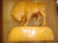 Front view of entire wooden buffalo sculpture on base