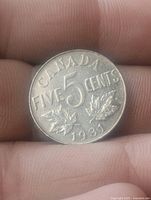 Reverse showing CANADA FIVE CENTS 1931 with maple leaves