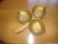 Top view of solid brass three-section leaf dish on tabletop